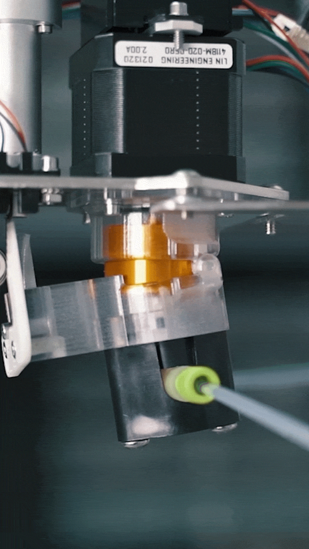 Close-up of laboratory equipment with gold spindle rotating rapidly while attached to a metallic frame