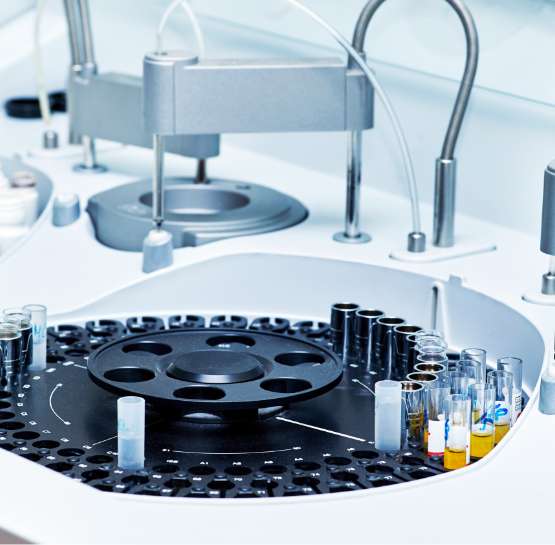 Close-up of a modern laboratory analyzer with test tubes on a rotating tray